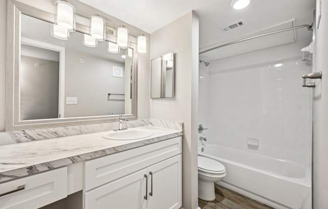 Stylish bathroom area in the D5 floor plan at Windridge On The Parkway Apartments in Dallas, TX