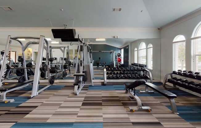 a large fitness room with treadmills and other exercise equipment