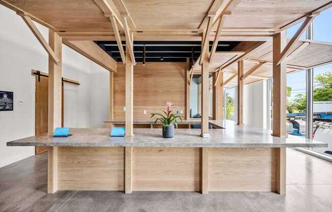 A wooden table with a plant on it in a room with wooden beams.