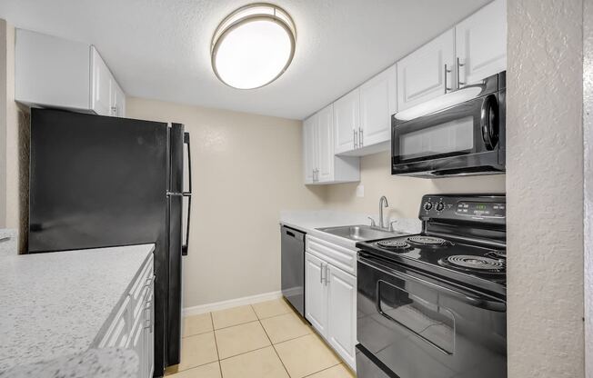 a kitchen with stainless steel appliances and white cabinets