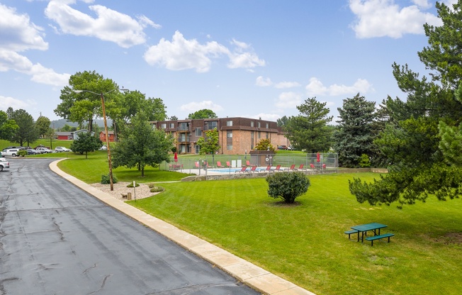 A road with a green bench on the side.