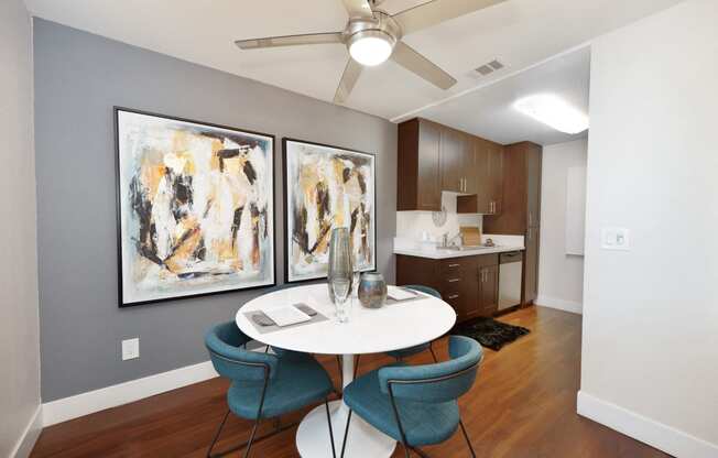 a dining room with a table and chairs and a kitchen