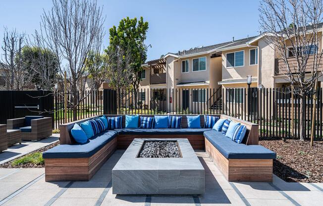 blue couch and pillows surrounding a fire pit