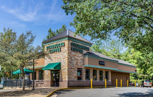 the facade of a restaurant with a street and trees