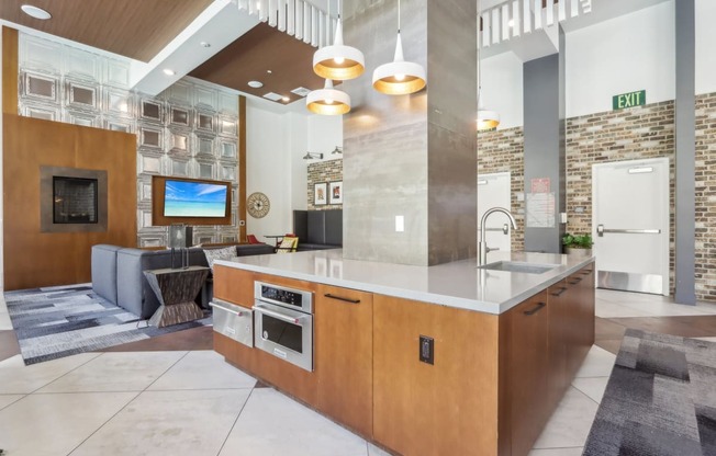 a kitchen with a large island and a living room with a fireplace