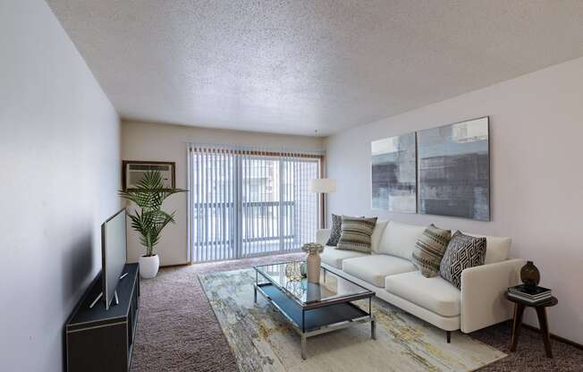 a living room with a couch and a coffee table. Moorhead, MN South Park Apartments