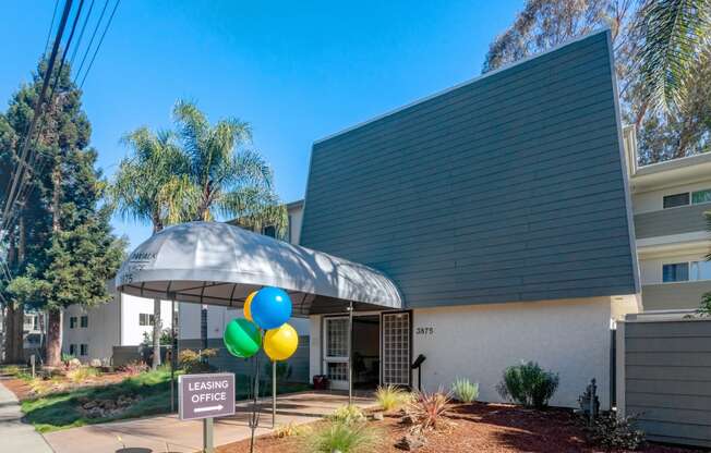 a building with an umbrella and balloons in front of it