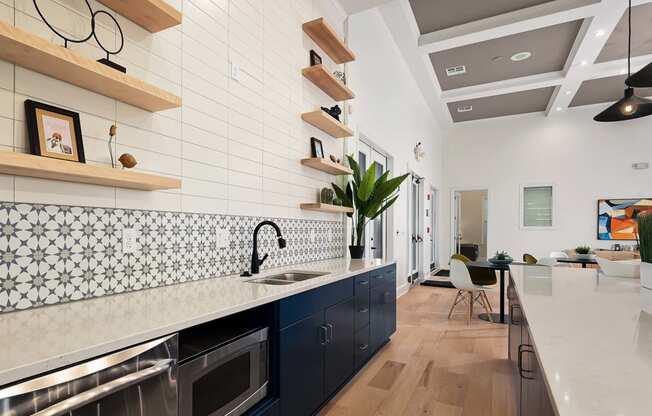 a kitchen with a long counter top and a sink at Sovereign at Overland Park, Overland Park  