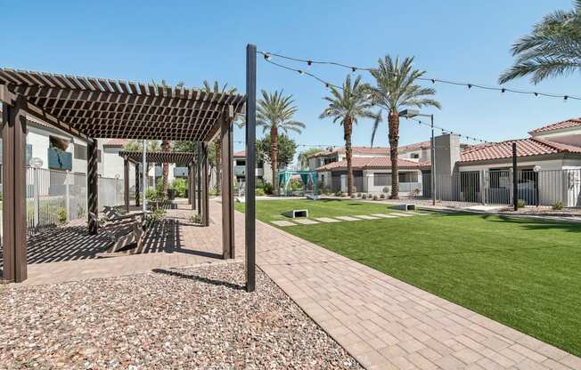 the yard of a house with a lawn and palm trees