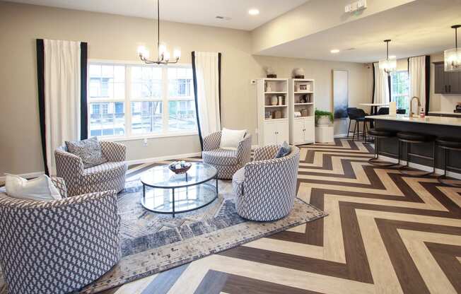 a living room with chairs and a table