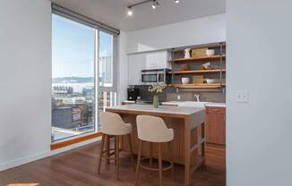 A kitchen with a view of the city.
