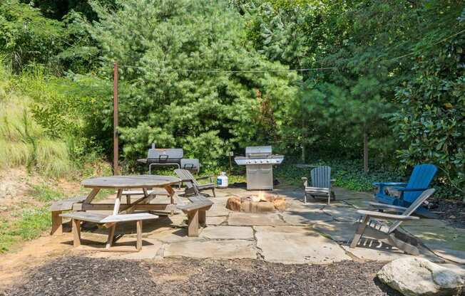 a patio with tables and chairs and a dog laying on the ground at River Mill Lofts & Skyloft, Asheville, 28803