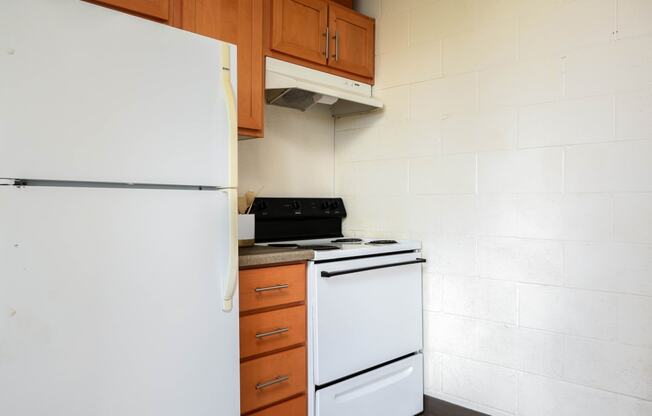 a kitchen with a white refrigerator and a stove