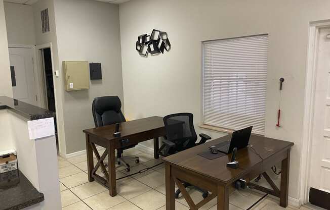 an office with two desks and two chairs at Colonial Apartments, Orlando