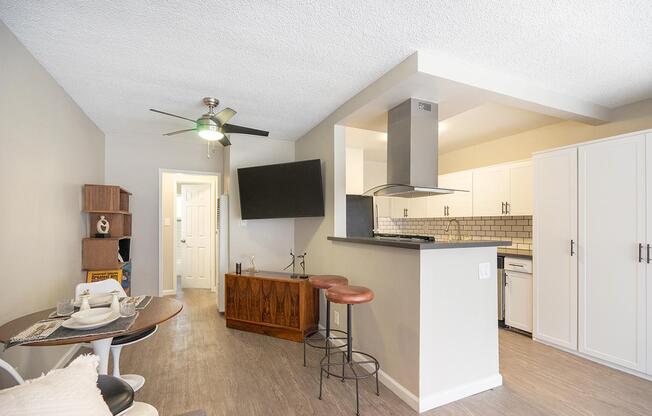 a living room filled with furniture and a refrigerator