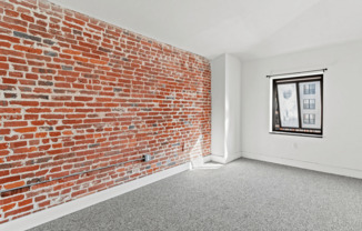 Embrace the charm of this urban retreat with its exposed brick wall and natural light.