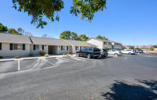 a parking lot with cars in front of a building