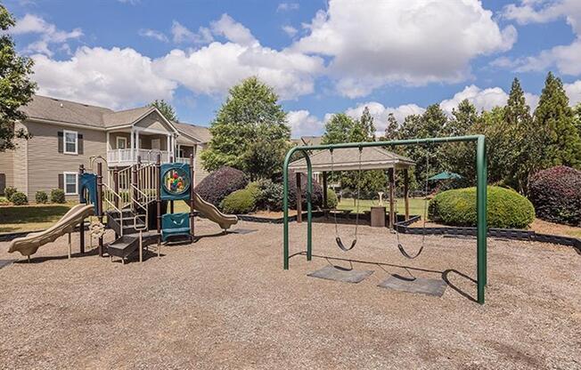 a playground with a swing set and a jungle gym at Bedford Parke Apartments, Georgia