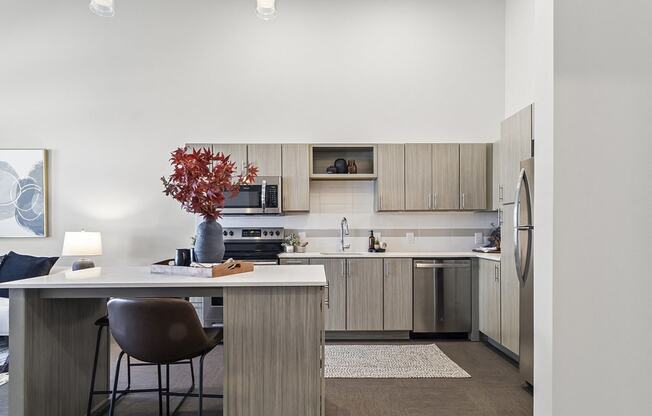 a kitchen with wooden cabinets and a table with a chair