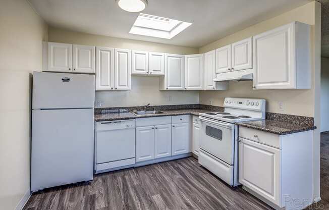 a kitchen with white cabinets and white appliances at Terrace View Apartments, Daly City, CA 94015