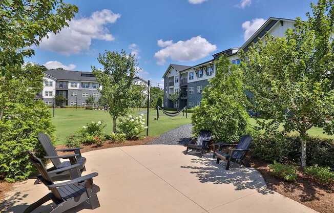 A sunny day at a park with chairs and trees.
