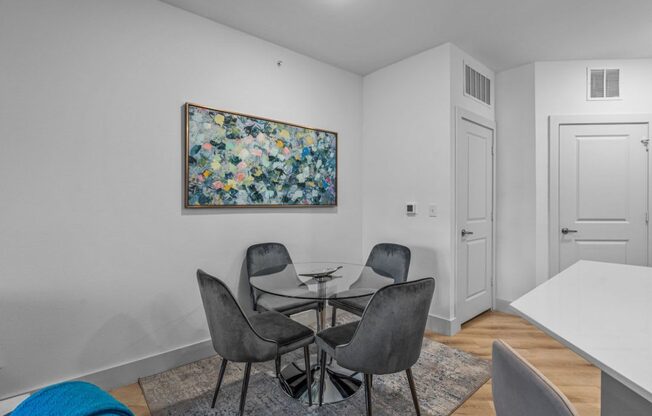 a dining room with a table and chairs