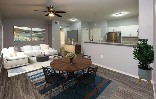 an open living room and kitchen with a table and chairs