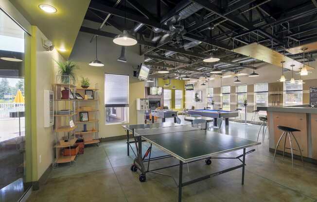 a room with a ping pong table in the middle at Village Club of Rochester Hills, Michigan, 48317