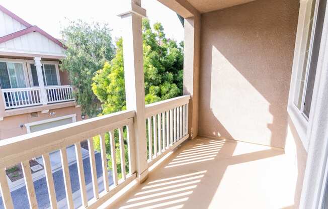 a balcony with a view of trees and a house at The Vines at Riverpark, LLC, California, 93036