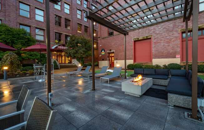 a patio with couches and a fire pit