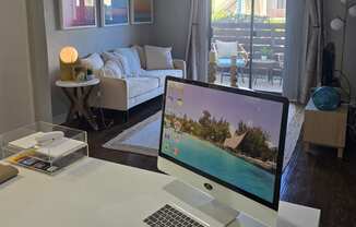 a desk with a computer on it in a living room