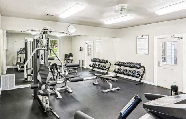 Fitness center with cardio machines and weights at Hunters Chase in Austin, TX