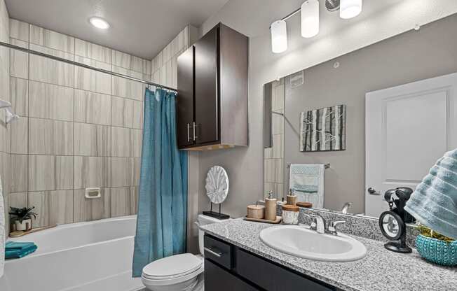 a bathroom with a sink and a toilet and a tub