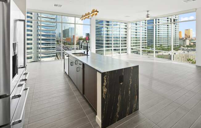 the kitchen has a large island with a view of the city at Aura Vegas Apartments, Las Vegas, Nevada