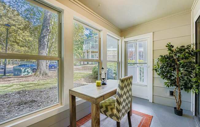 A dining room with a table and chairs.