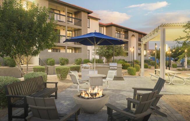 a patio with chairs and a fire pit