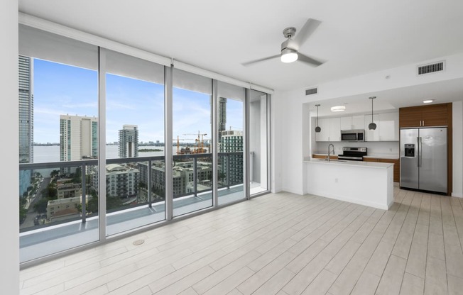 a living room with a large window and a view of a city