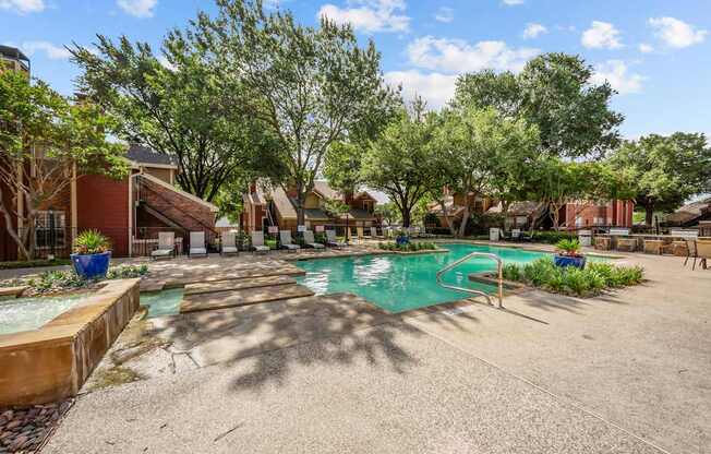 A pool surrounded by trees and a building in the background.