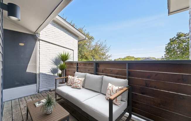 a balcony with a couch and a table
