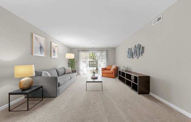 Spacious Living Room with Sliding Glass Door at Lakeside Village Apartments Clinton Township MI