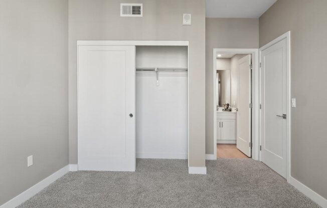 an empty bedroom with a closet and view to a bathroom at Arrive Temecula