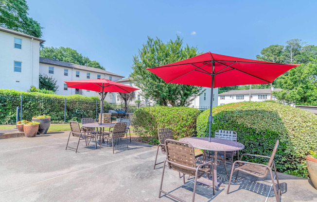 a patio with tables and umbrellas at Avondale Station Apartments, Decatur