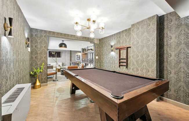 A pool table is in the middle of a room with a vintage feel.