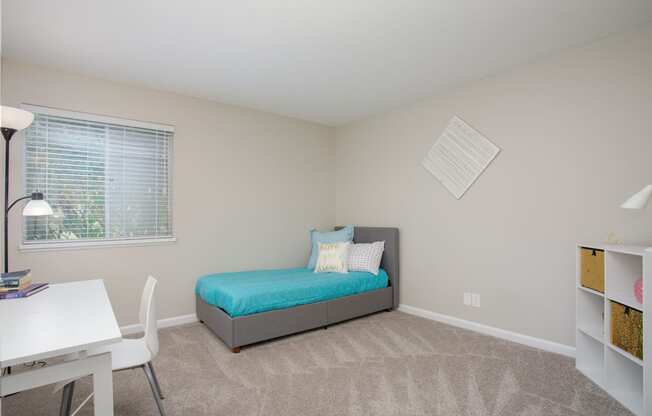Guest bedroom with large window at Malibu at Martin Apartments in Huntsville, Alabama