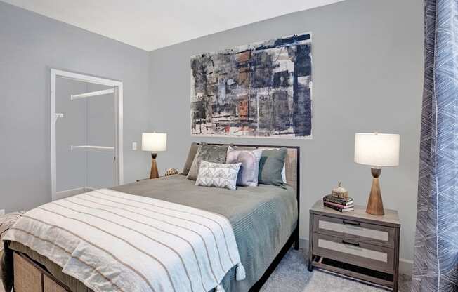 a bedroom with a bed and a painting on the wall