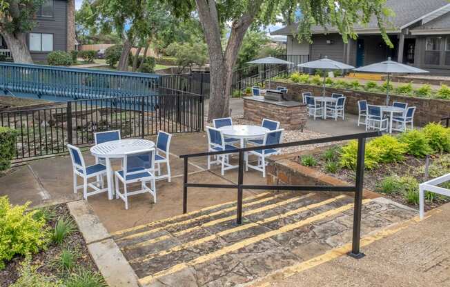 a patio with tables and chairs and a pool