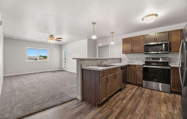 A kitchen with wooden cabinets and a stainless steel oven.