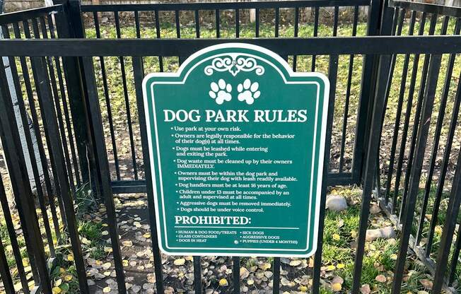 A sign in a dog park outlines the rules for visitors.