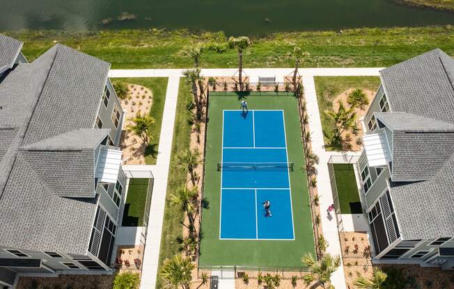 an aerial view of a tennis court with a player on the court at Palm Grove in Ellenton, FL 34222