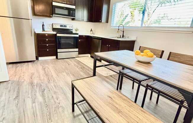 Campbell Plaza Apartments
710 Nido Drive, Campbell, CA 95008. A kitchen with a table and chairs in front of it.
